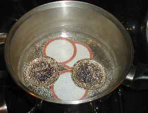 lids, in a pot of steaming hot, but not boiling water